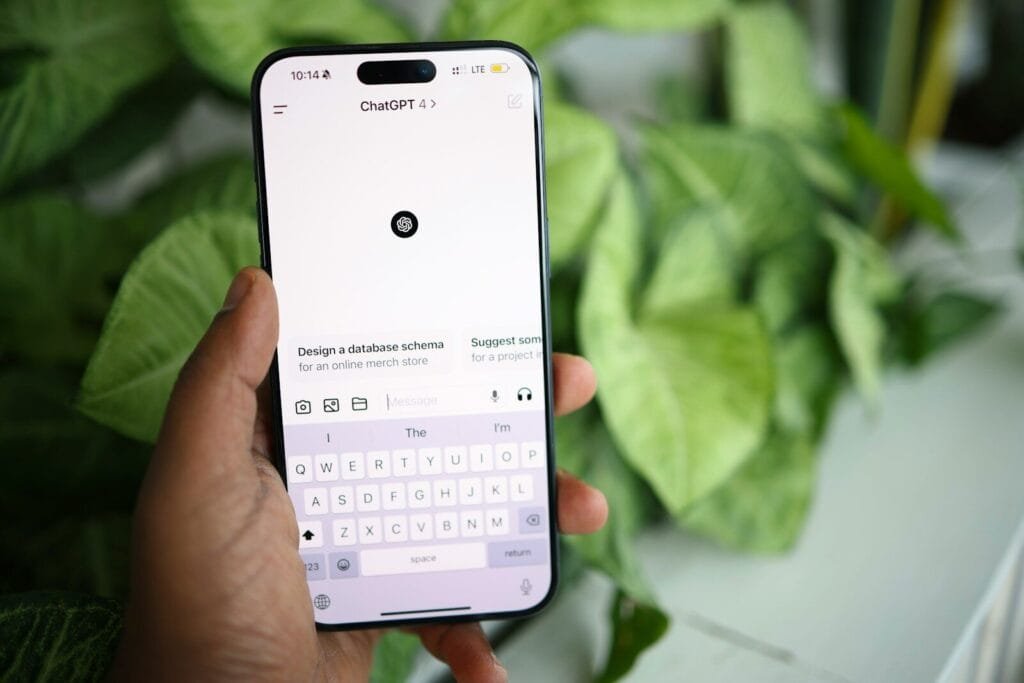 A Person Holding A Cell Phone In Their Hand